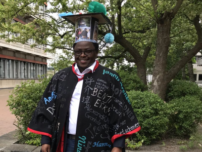 Amon Kimeli with his doctoral hat and gown