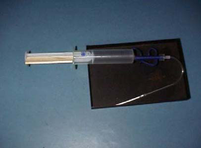 Rhizone water sampler with female female Luer adapter and syringe attached.