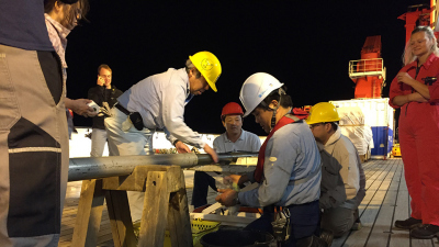 Scientists analysing a drill core on the research vessel SONNE during an expedition off the coast of Japan in 2016. Photo: T. Schwestermann