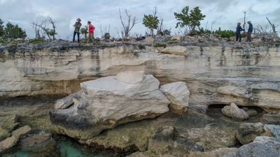 A new study of shorelines in the Bahamas may change estimates of past sea levels. Here, some of the authors survey coastal rocks on the archipelago’s Crooked Island formed when sea levels were higher. Photo: Blake Dyer