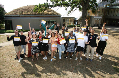 group photo of people waving certificates in their hands