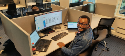 Opeyemi sitting at a desk in front of a computer