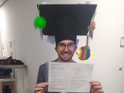 Mattia with doctoral hat and certificate