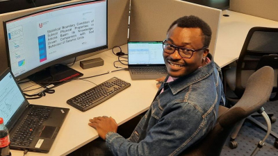 Opeyemi sitting in front of a computer