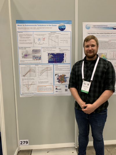Ilmar standing next to his poster