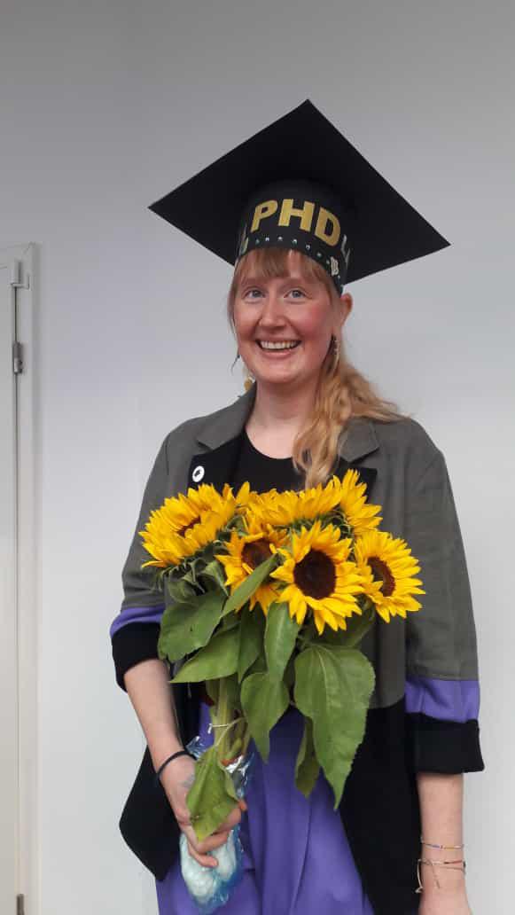 Lara Stuthmann with her doctoral hat and flowers