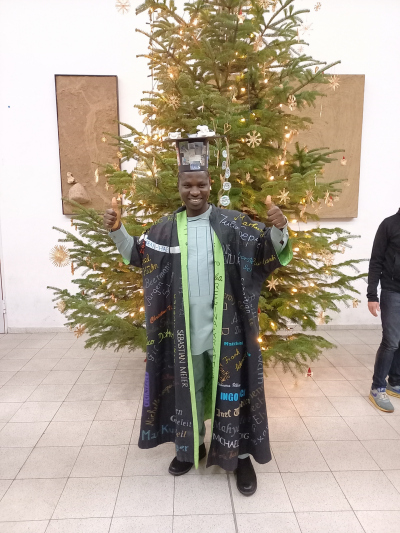 Emmanuel Okuma with his doctoral hat and cape