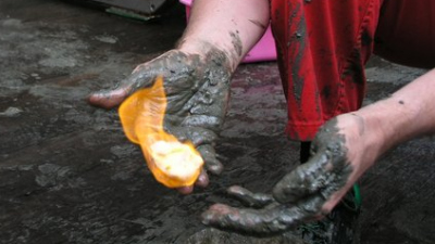 hands with mud and burning gas hydrates